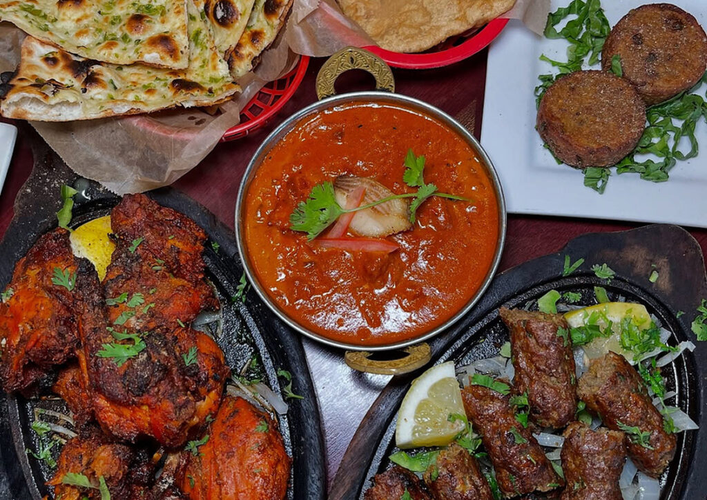 Indian mixed grill platter with tandoori chicken, seekh kebab, curry, and naan at Taj Palace in Las Vegas